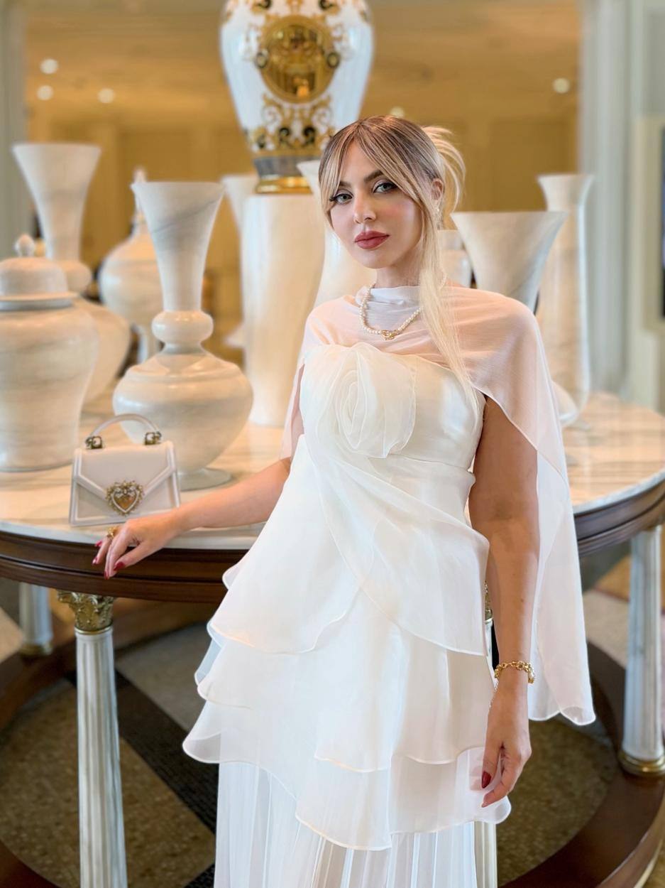 Pearla in a white gown in the lobby of Palazzo Versace Dubai
