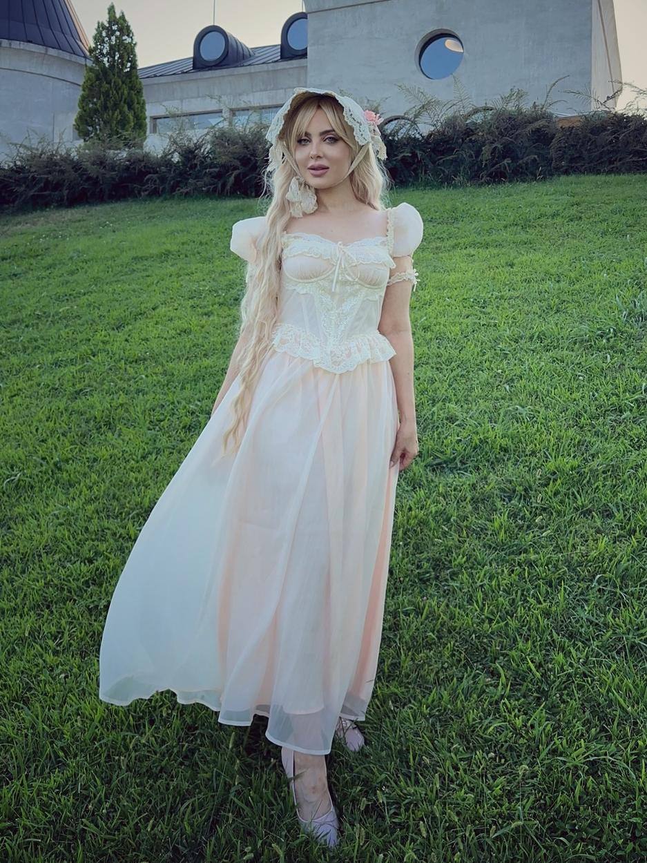 Pearla in a cream gown on the lawn at Lopota Lake Resort